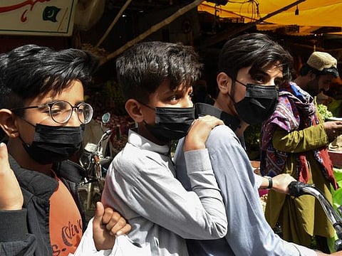 In pictures: Pakistanis rush to buy face masks after first two confirmed coronavirus cases were reported in the country