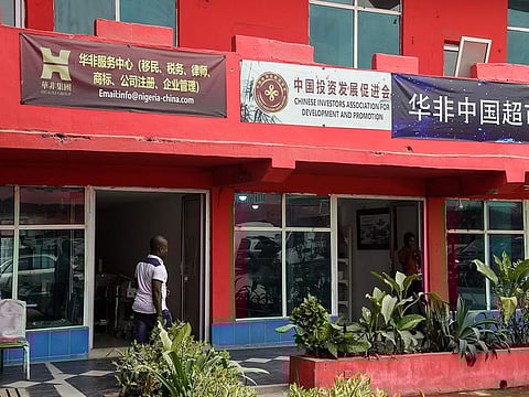 A man walks past empty shops in the deserted China Commercial City shopping centre, popularly called "China Town", in Ojota in Lagos, as people fear of contracting the COVID-19, the novel coronavirus on February 27, 2020. 