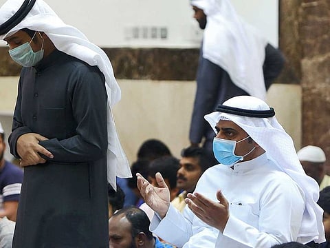 Worshippers wearing protective masks perform at a mosque in Kuwait City on February 28, 2020. 
