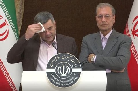 The head of Iran's counter-coronavirus task force, Iraj Harirchi, left, wipes his face during a press briefing with government spokesman Ali Rabiei, in Tehran on February 24. Harirchi has tested positive for the virus himself.