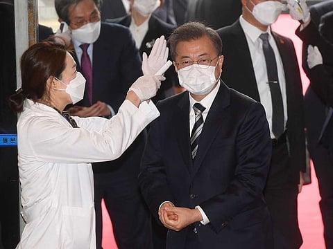 South Korean President Moon Jae-in has his body temperature checked as he arrives at the National Assembly in Seoul on Friday.