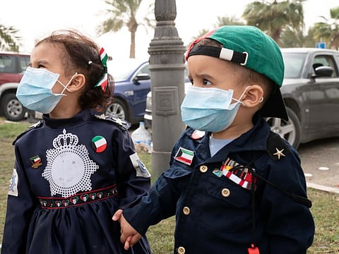 Kuwaiti kids wear protective face masks, following the outbreak of coronavirus, during celebrations of the 29th Kuwait Liberation Day from the Iraqi occupation, in Kuwait on February 26.