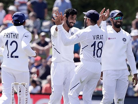 India's Jasprit Bumrah, centre, is congratulated by his captain Virat Kohli (second right) and teammates after dismissing New Zealand's Tim Southee during play on second day of the second Test Hagley Oval in Christchurch, New Zealand on Sunday. 