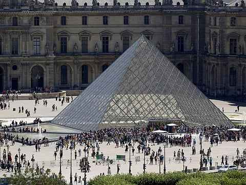 People line up at the Louvre Museum as the staff closed the museum during a staff meeting about the coronavirus outbreak, in Paris, France, March 1, 2020. 