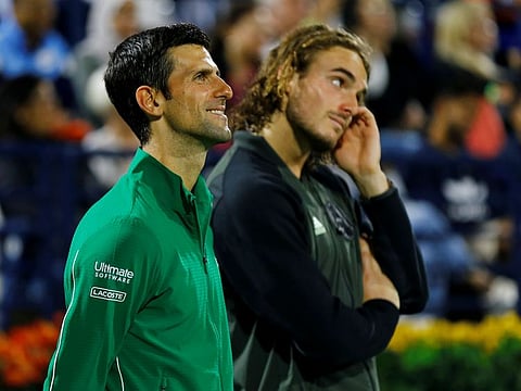 Stefanos Tsitsipas (right) wears a disappointed look as he stands next to men's champion Novak Djokovic at Dubai Duty Free Tennis Championships on Saturday night. 