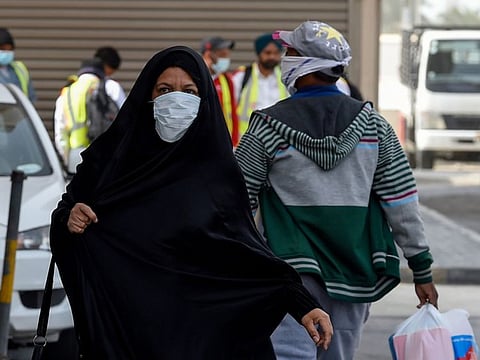 People wearing masks seen in the heart of the Bahraini capital Manama on February 26, 2020.