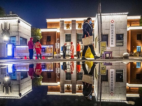 Staff disinfecting the premises after all patients were discharged at a makeshift hospital set up in a sports stadium in Wuhan in China's central Hubei province. 