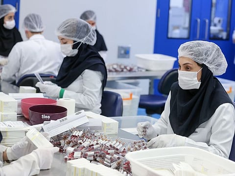 Pharmaceutical factory workers package vitamin and mineral supplement ampoules at the Actoverco plant in Karaj, about 40 kilometres west of Iran's capital Tehran, on February 18.
