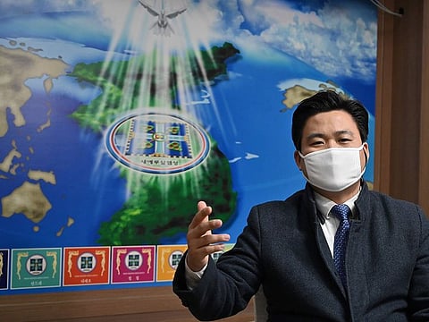 This photo taken on March 1, 2020 shows Kim Shin-chang, director of international missions at the Shincheonji Church of Jesus, wearing a face mask as he speaks during an interview with AFP at the headquarters of the church in Gwacheon, south of Seoul.