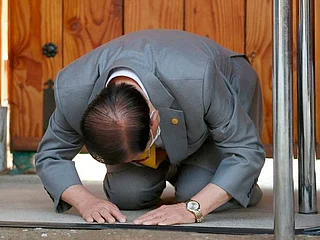 Kneeling, South Korea's sect leader seeks forgiveness for coronavirus spike