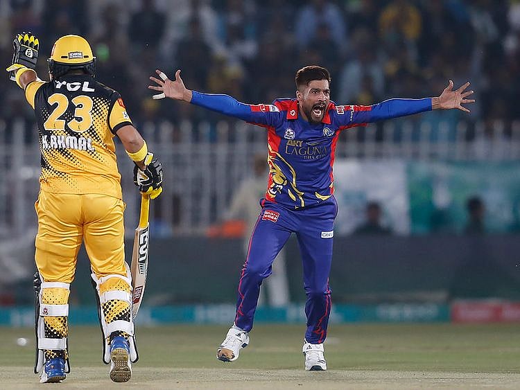 Karachi Kings pacer Mohammad Amir, right, appeals successfully LBW out of Peshawar Zalmi batsman Tom Banton during their Pakistan Super League T20 cricket match in Rawalpindi, Pakistan, Monday