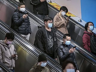 New normal in virus-hit China: High-tech tracking and fever checks