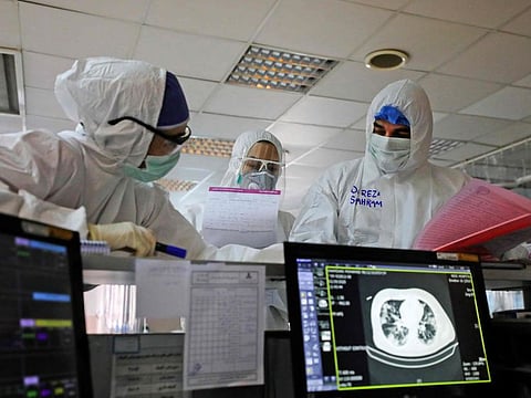 Iranian medical personnel, wearing protective gear, work at the quartine ward of a hospital in Tehran. 