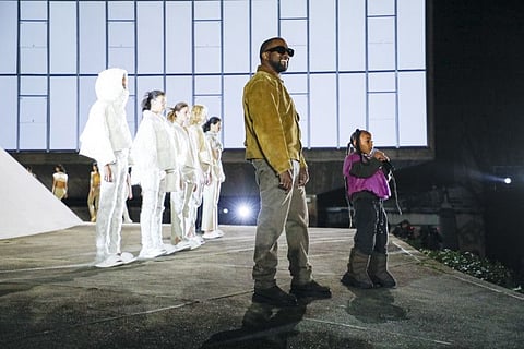 Kanye West and his elder daughter, North, during the finale of his Yeezy Season 8 show in Paris.