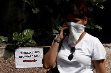 A woman walks inside the premises of a hospital where a special ward has been set up for the coronavirus disease in Mumbai.