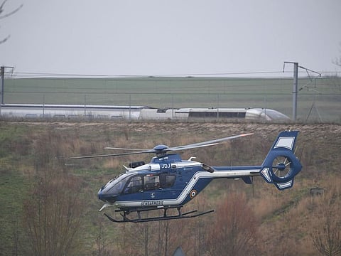 A Gendarmerie helicopter flies near the site where a high-speed TGV train locomotive derailed close to Inhenheim early on Thursday while travelling from Strasbourg to Paris.