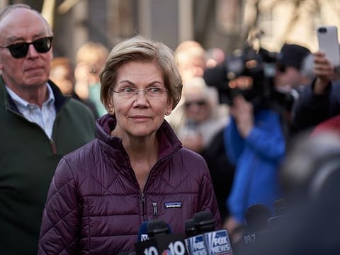 Sen. Elizabeth Warren, a former Democratic presidential candidate, listens to questions during a news conference in front of her house in Cambridge, on Thursday. Warren announced her exit from the presidential primary during the conference and did not immediately endorse another candidate.