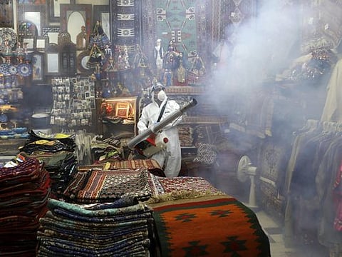 A firefighter disinfects a traditional shopping center to help prevent the spread of the new coronavirus in northern Tehran on March 6.
