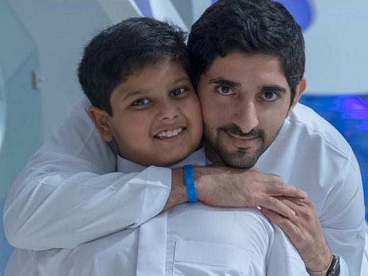 Sheikh Hamdan Bin Mohammad Bin Rashid Al Maktoum with cancer survivor Abdullah Hussain  