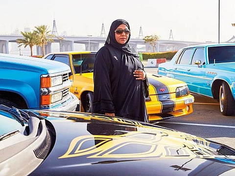 Salwa Tarish Mohammad Ibrahim Salem poses with her beautiful classic cars.