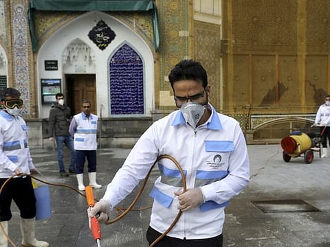 Workers disinfect a Shiite shrine to help prevent the spread of the new coronavirus in Shahr-e-Ray, south of Tehran, March 7.