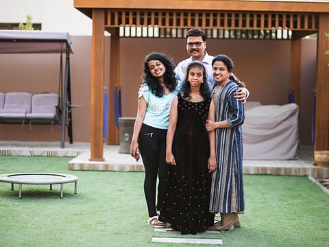 Navya Karapath Bhaskaran centre with her family