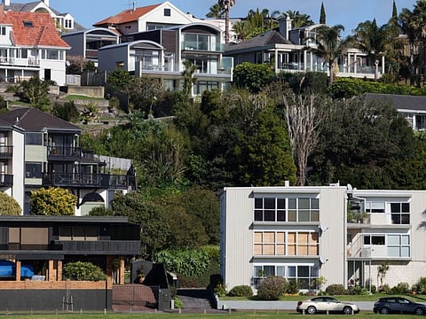 Houses stand in the suburb of Saint Heliers in Auckland, New Zealand. Residents are piling pressure on the government to address a chronic shortage in affordable housing.