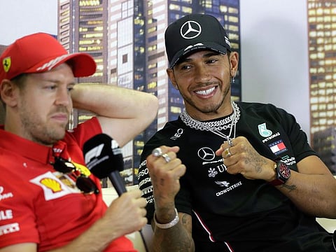 Mercedes ace Lewis Hamilton (right) strikes a pose Ferrari driver Sebastian Vettel, one of his top rivals, during a press conference at the Australian Formula One Grand Prix in Melbourne.