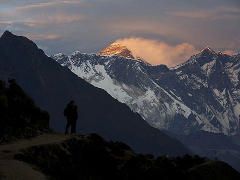 Light illuminates Mount Everest (C) during sunset in Solukhumbu district, also known as the Everest region, in this picture taken on November 30, 2015.
