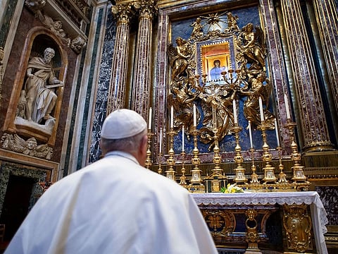 This handout picture released by the Vatican Media shows Pope Francis praying in Rome's Santa Maria Maggiore basilica, on March 15, 2020