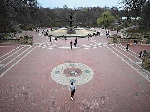 People enjoy the sun in Central Park in New York City.  