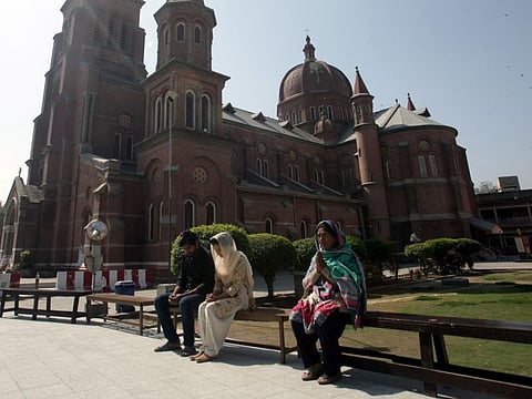 People pray outside the Sacred Heart Cathedral as it was closed after Pakistan shut all its schools and discouraged large gatherings amid coronavirus fears in Lahore, March 15.
