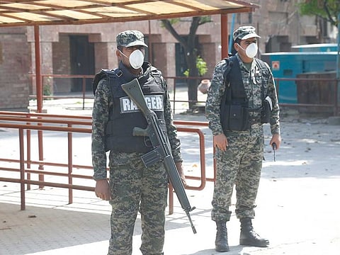 Pakistan Security personnel stand guard outside the Gaddafi Cricket Stadium in Lahore, Pakistan on  Tuesday, March 17, 2020. The PSL has been postponed amid the coronavirus pandemic. 