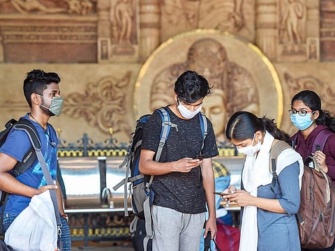 Passengers wear masks as a preventive measure against coronavirus, at Lokmanya Tilak Terminus in Mumbai, on March 17, 2020. 