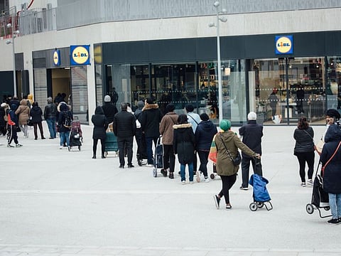 Shoppers queue to purchase supplies outside a Lidl Ltd. supermarket ahead of the implementation of increased lockdown measures to control the spread of coronavirus in the Bagnolet district in Paris on Tuesday, March 17, 2020.