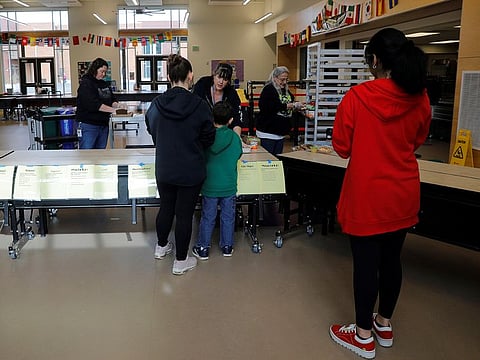 Children pick up lunch at the Olympic Hills Elementary School, after schools were closed due to the coronavirus disease (COVID-19) outbreak, in Seattle, Washington, US, March 17, 2020.