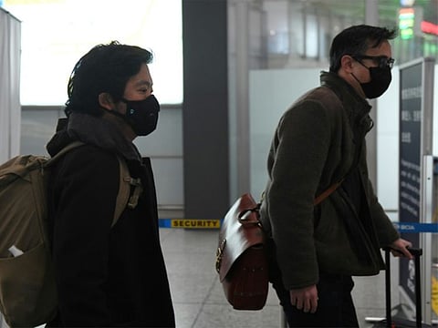 Wall Street Journal reporters Josh Chin (right) and Philip Wen walk through Beijing Capital Airport as they are expelled in February 2020 over a controversial headline in an op-ed in the newspaper.
