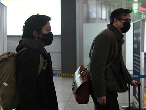 Wall Street Journal reporters Josh Chin (right) and Philip Wen walk through Beijing Capital Airport as they are expelled in February 2020 over a controversial headline in an op-ed in the newspaper.