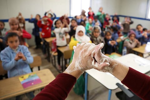 Syrian refugee students take part in a washing hands activity during an awareness campaign about coronavirus initiated by Oxfam and Unicef at Zaatari refugee camp in the Jordanian city of Mafraq, near the border with Syria, March 11.