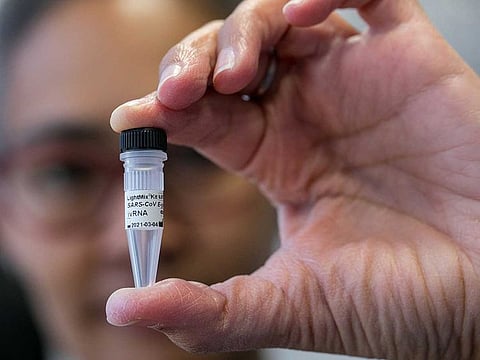 A lab worker poses with a vial used in a coronavirus diagnostic test kit at the TIB Molbiol Syntheselabor GmbH production facility in Berlin, Germany, on March 6, 2020.