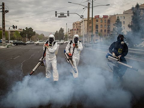 Firefighters use fog machines to disinfect public streets following the outbreak of coronavirus in Tehran