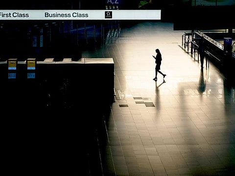 A passenger walks through an almost deserted terminal at the airport in Frankfurt, Germany.  