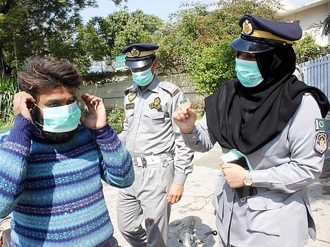 Traffic Police wardens in Islamabad distribute face masks as part of awareness campaign to prevent coronavirus spread.