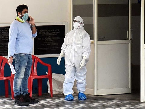 Illustrative purposes only: A man wearing a face mask speaks on his mobile phone outside the Special Isolation Ward of coronavirus patients at Aluva government general hospital in Kochi on Thursday. 