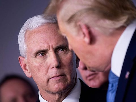 US Vice President Mike Pence and US President Donald Trump talk during a COVID-19 pandemic briefing at the White House in Washington, DC
