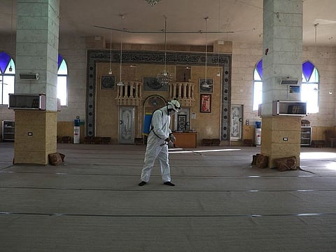 A member of the Syrian Civil Defence known as the "White Helmets" disinfects the interior of a mosque, as part of preventive measures taken against infections by the novel coronavirus, in the Syrian town of Dana, east of the Turkish-Syrian border in the northwestern Idlib province, on March 22, 2020.
