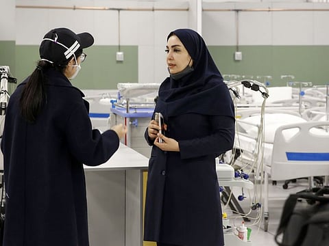 An Iranian health inspector checks a makeshift hospital set up inside the Iran Mall, northwest of Tehran, on March 21.