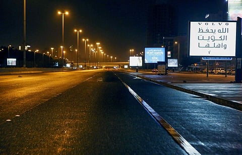 A photo taken on March 22 shows a deserted street in Kuwait city amid the COVID-19 coronavirus pandemic. Kuwait imposed a curfew nationwide starting on Sunday at 5pm until 4am to fight the spread of the coronavirus, state news agency KUNA said.  