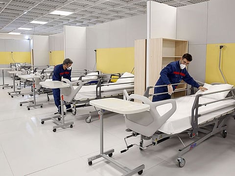  Iranian workers set up a makeshift hospital inside the Iran Mall, northwest of Tehran, on March 21, 2020 amid the coronavirus outbreak. 
