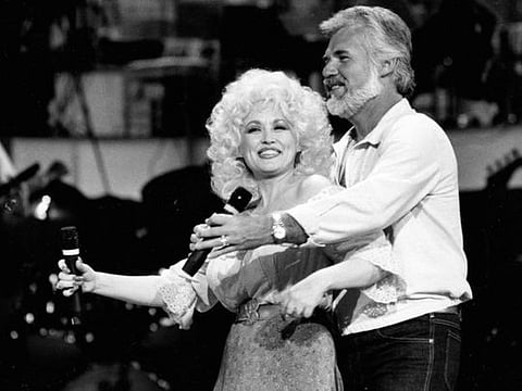 This 1983 file photo, Country Music singers Dolly Parton and Kenny Rogers 